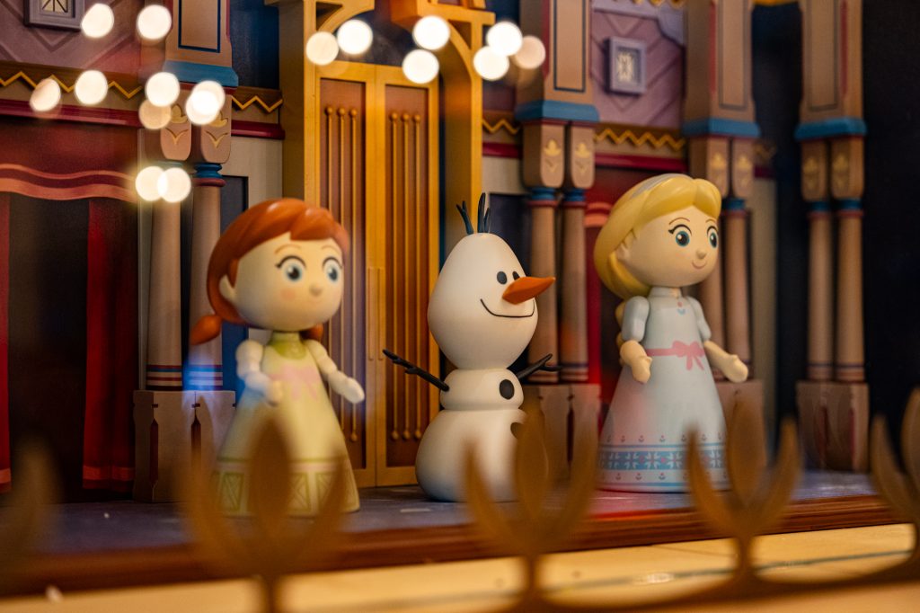 wooden representation of Arendelle Castle featuring adorable sculptures of Anna, Elsa, and Olaf.